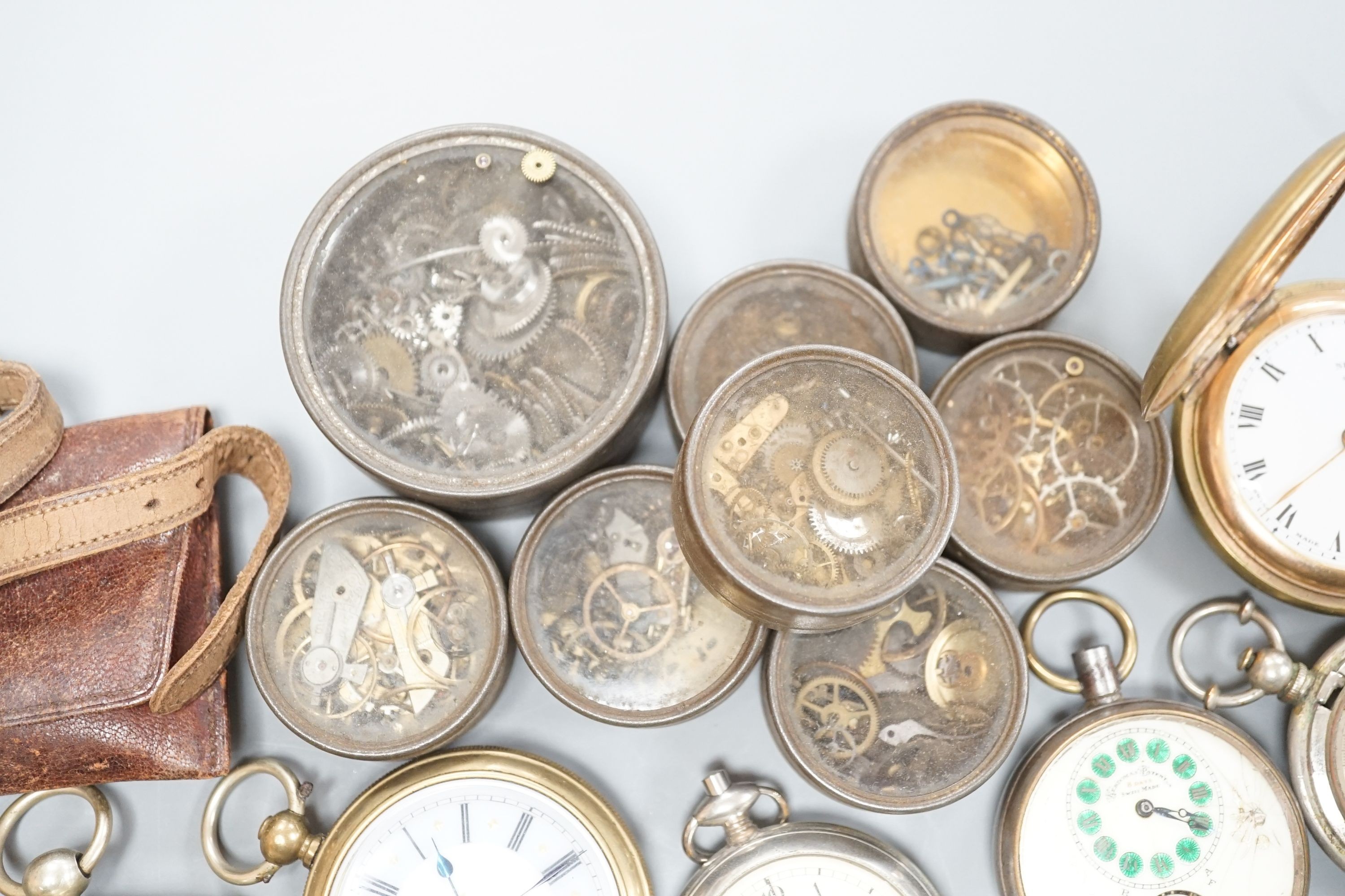 A small collection of assorted base metal and gold plated pocket watches including Hebdomas and Waltham and a small quantity of watch parts.